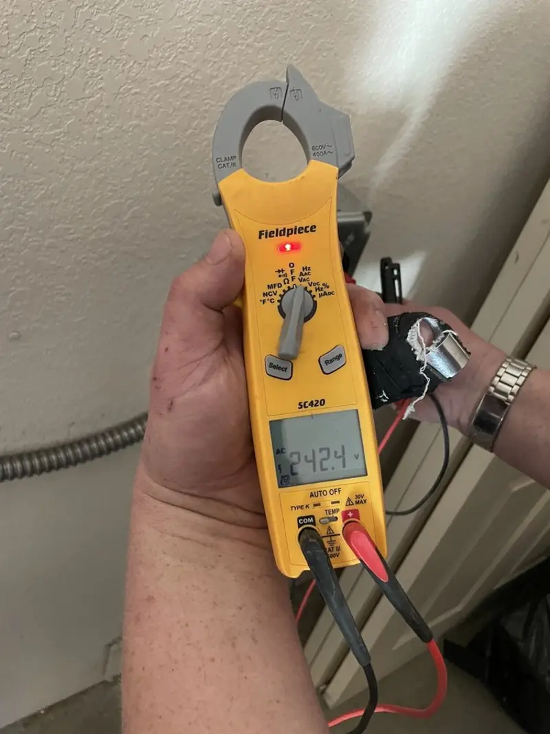 Voltage testing with clamp meter during Electrical Installation Services in Four Square Mile